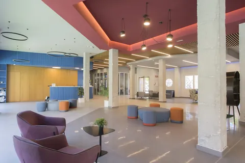Nuevo hall de la residencia con zonas de estar y recepción al fondo